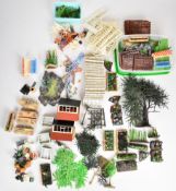 A collection of Britains Flora Garden including raised beds, garden furniture, tools, fences and