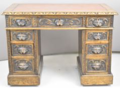 Victorian carved kneehole pedestal desk with carved mask handles, fitted six drawers, W107 x D59 x