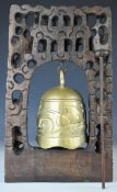 Chinese / Tibetan brass bell / gong suspended on a carved hardwood stand decorated with fish with