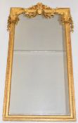 19th century gilt framed mirror with beaded and moulded border, the top having central motif flanked