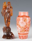 Chinese amber figure of an immortal and a Chinese vase with peony decoration, largest 12cm tall.