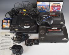 Three Sega retro games consoles comprising a Mega-Drive and two Master System II, together with