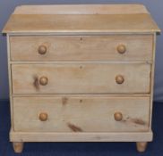 Victorian pine chest of three graduated drawers with bun handles, raise on turned legs, W90 x D44