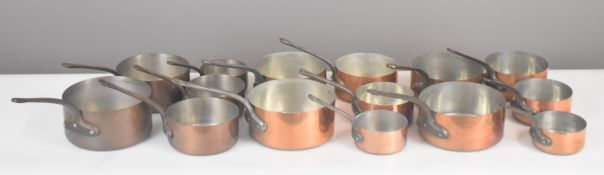 Three sets of five copper saucepans, length of largest 41cm