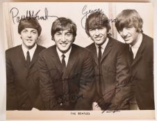 Autographed black and white photograph of The Beatles with signed with dedication 