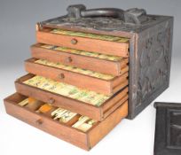 Chinese or similar Mahjong set with bone and bamboo tiles, in five drawer carved wooden cabinet with