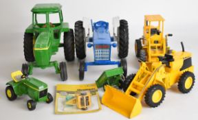 Five ERTL diecast model tractors and diggers to include John Deere and Ford, largest H19cm x L25cm
