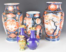 Six Japanese and Chinese vases including a pair of Imari pedestal vases, a similar lobed vase and