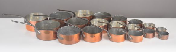 Three sets of copper saucepans comprising two sets of seven and one set of five, length of largest