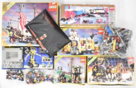 A quantity of 1980's / 90's Lego sets including 6285, 6270, 8852, 6245, 6276, 6987, 6971, together