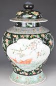 Chinese 19th / 20thC famille noir covered vase with exotic bird and fish decoration and double