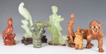 Seven Japanese and Chinese carved figures including a tiger, Guanyin, jadeite / hardstone etc,