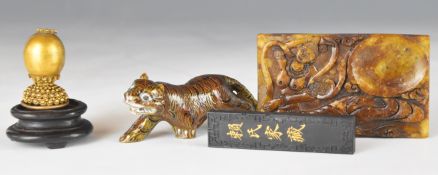 Four Chinese items comprising 19thC gilt metal hat finial on stand, enamelled tiger, carved