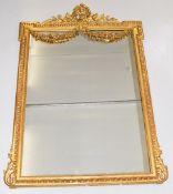 19th century gilt framed mirror with egg and dart border, the top having foliate sprigs, triumphal