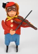 Schuco clockwork tinplate monkey in felt clothing playing a violin, stamped Made In Germany to