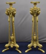 Pair of Empire style gilt torchère stands, with ram's head, swag and foliate decoration, raised on