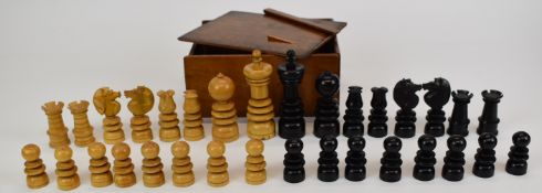 A turned wooden chess set in ebony and boxwood or similar, height of king 10cm.