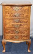 Walnut bow fronted music chest of six drawers with hinged drawer frontages, raised on cabriole legs,