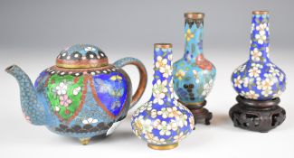 Four Chinese cloisonné miniature vases and teapot, two on wooden stands, largest 7cm tall.