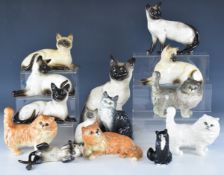 Fourteen Beswick cat figures including many Siamese / Persian etc