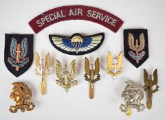 Eleven Special Air Service badges including cloth wings and shoulder title, two piece cap badge,