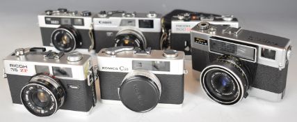 Six 35mm film cameras comprising Canon QL, Fujica Auto-M, Ricoh 500 GX, Ricoh 35 ZF, Prinz 35-E