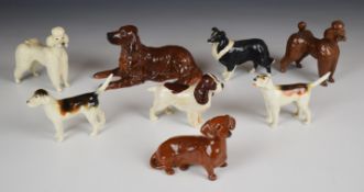 Eight Beswick dog figures including Red Setter, two first version hounds, poodle, Jack Russell