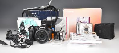 Two digital cameras comprising Panasonic FZ200 Lumix with Leica 1:2.8/4.5-108 lens and Canon Power