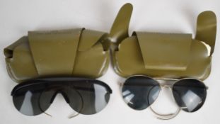 Two pairs of US military sunglasses, in original pouches, dated 1972