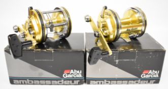 Two Abu Ambassadeur multiplier fishing reels, both boxed with paperwork and accessories, new /