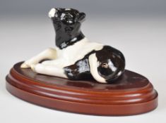 Beswick model of a Friesian calf lying down, on wooden plinth, possibly a prototype, height 8cm