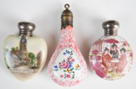 Three 19thC porcelain and enamel scent / perfume bottles, two with hallmarked silver mounts