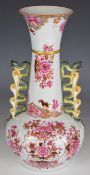 Spode stone china pedestal vase with twin handles decorated in the famille rose palette, with