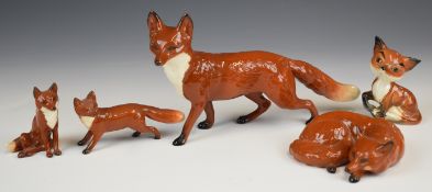 Five Beswick fox figures including comical fox, tallest 13cm