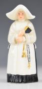 Royal Worcester candle snuffer modelled as a nun, with puce mark to base, height 9.5cm