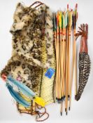 A collection of Native American style items including arrows with fur covered quiver, clothing