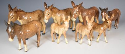 Eight Beswick donkey figures, tallest 14cm