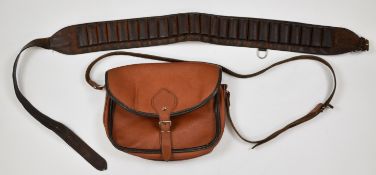 Two shotgun cartridge accessories comprising a leather cartridge bag and a 12 bore cartridge belt.