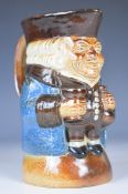 Royal Doulton toby jug holding a bottle and glass, model no 8572 to base, height 15.5cm