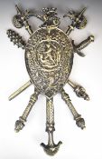 Metal military shield with dragon to top and warrior slaying a serpent to centre, 66 x 45cm