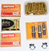 A collection .270 rifle cartridge re-loading dies and empty brass cases.