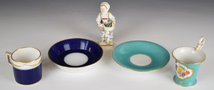 Meissen figure of a girl with basket of grapes and two Meissen cups and saucers, tallest 10cm