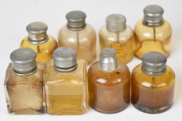 Eight gun case metal topped glass oil bottles including G & J W Hawksley, Hillas's Prize Medal Oil