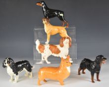 Six Beswick dog figures including Cavalier King Charles spaniels (one matt), Doberman, Corgi etc
