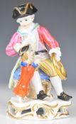 Meissen 19thC figure of a man with a performing dog jumping through a hoop, height 12cm