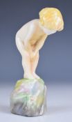 Royal Doulton figurine of a child on a rock, unusually painted with a crab clinging to the rock,