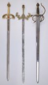 Three replica swords, one with Spanish knight on horseback, decorated crosspiece and part