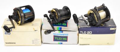 Three Shimano TLD 20 and 15 multiplier fishing reels, all boxed, two with paperwork / accessories