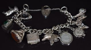 Silver charm bracelet with eight silver charms including bible, 46g