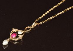 Art Nouveau 9ct gold pendant set with a pink sapphire, seed pearls and a baroque pearl, on 9k gold